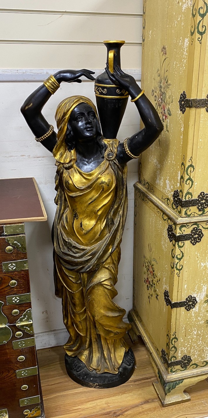 A pair of large gilded and brown patinated bronze figures of Nubian women holding amphoras, height 144cm